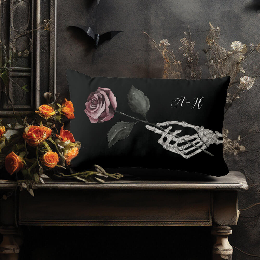 https://moodthology.com/wp-content/uploads/2023/10/gothic_halloween_black_wedding_skeleton_hand_rose_lumbar_pillow-r_8j8hrb_1080-2.jpg